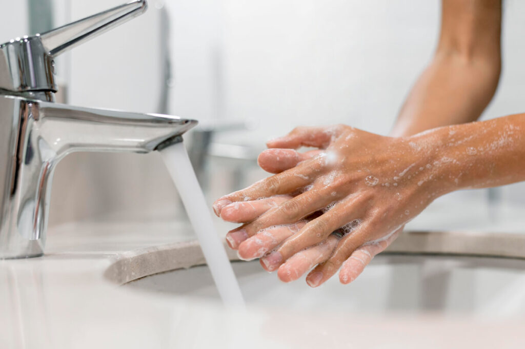 Mulher higienizando as mãos